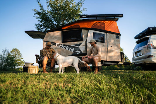 men and dog in front of camo TAXA cricket