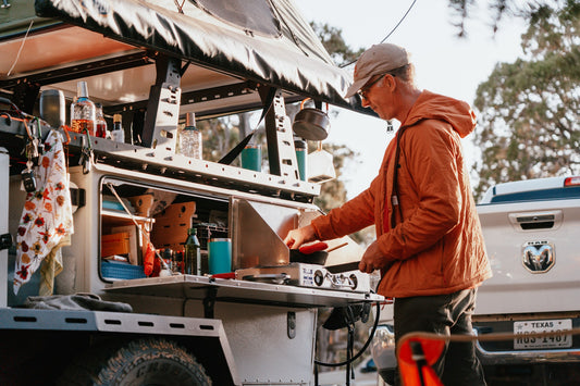 man cooking at a woolly bear kitchen setup