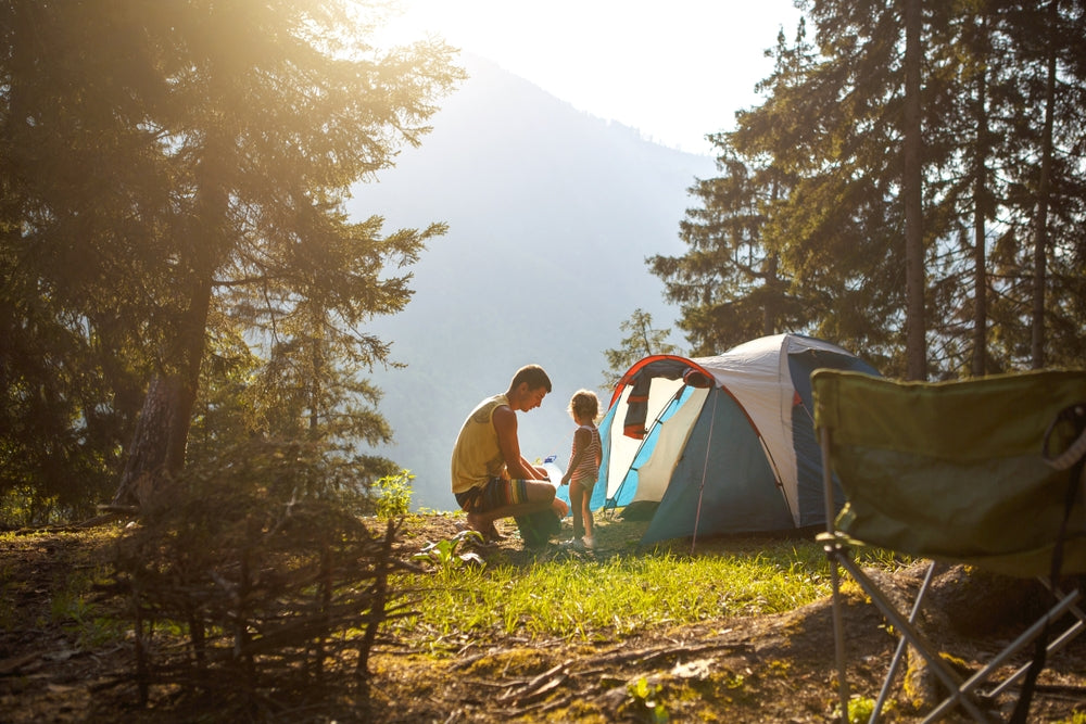 father and little daughter camping