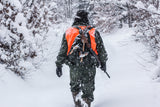 hunter in camo walking through snow